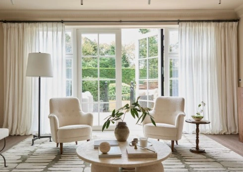 Apartment with big window sofa, table tv and concreate ceiling